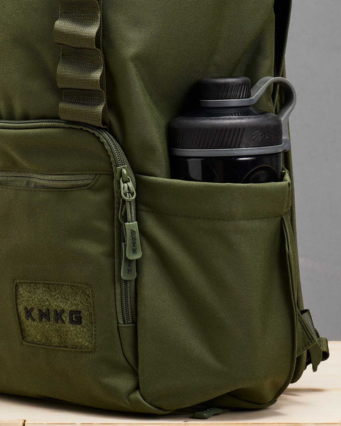 Shaker bottle inside large green CORE Backpack drink bottle pocket