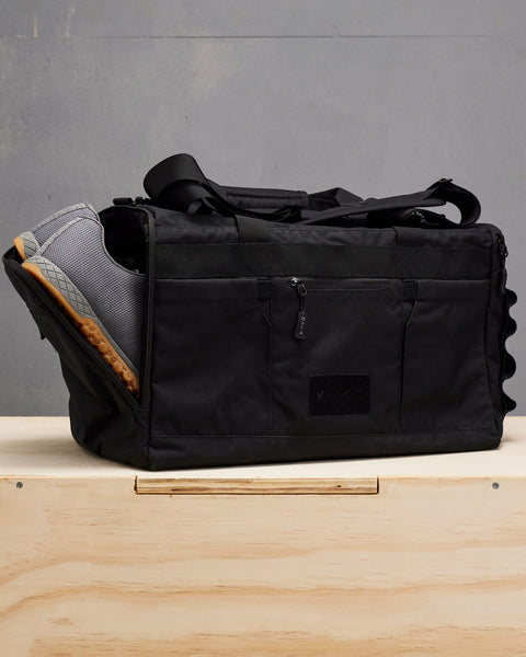 NOBULL sneakers inside black CORE Duffel shoe compartment