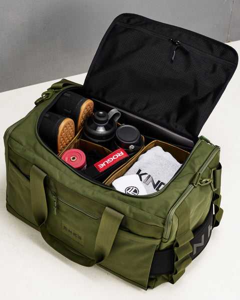Birds eye view of divider system inside of large green CORE Duffel packed with gym gear