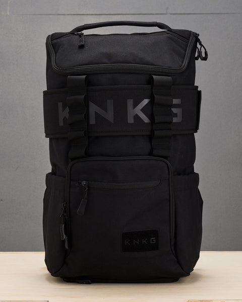 Black CORE Backpack with matching lifting belt sitting on wooden box