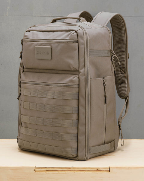 Side view of beige neutral large KNKG CONQUER Backpack