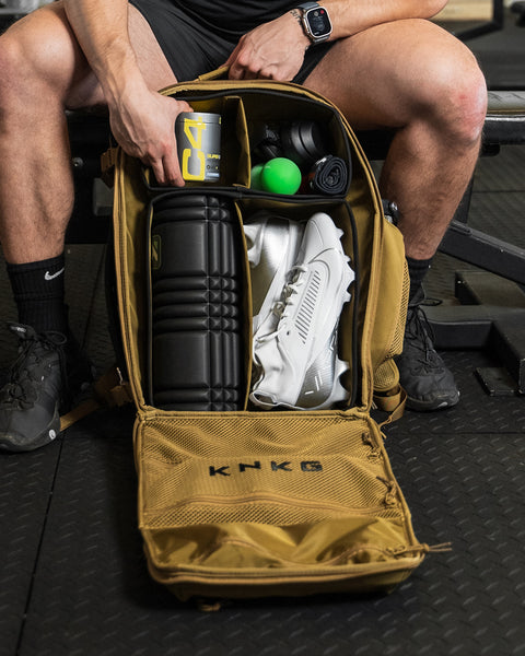 Internal dividers of desert CONQUER Backpack packed with foam roller, shoes, C4, Camera and various fitness gear