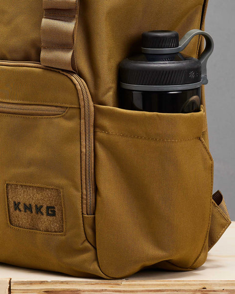 Shaker bottle packed inside of large desert CORE Backpack bottle pocket