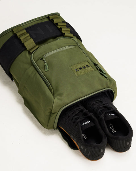 Sneakers inside green CORE Backpack shoe compartment