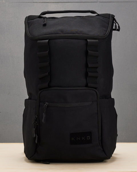 Black CORE Backpack sitting on wooden box