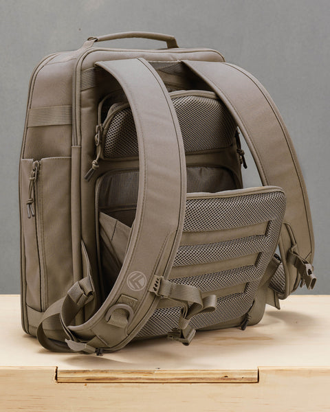 Back view of hidden concealed compartments of neutral beige KNKG CONQUER backpack