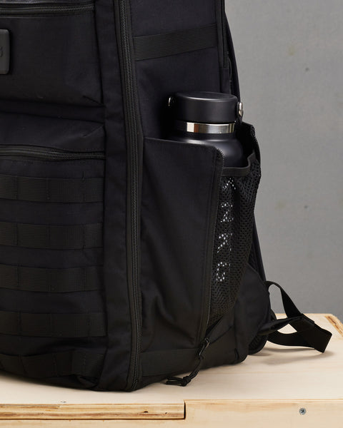 Drink bottle inside mesh pocket of large black CONQUER Backpack
