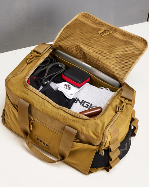 Birds eye view of large desert CORE Duffel packed with gym gear