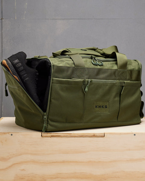 NOBULL sneakers packed inside large green CORE Duffel shoe compartment
