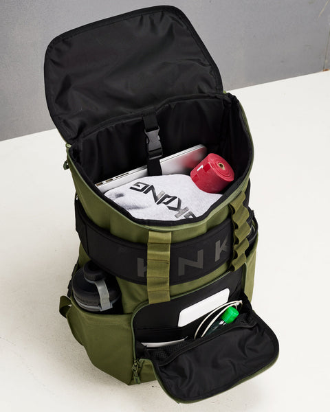 Internal view of large green CORE Backpack packed with laptop sleeve, hoodie, mobility accessories, shaker, drink bottle and EDC essentials