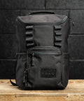 KNKG Mini CORE Backpack in Black sitting on wooden box inside gym
