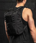 KNKG Mini CORE Backpack in Black being worn by male athlete inside gym