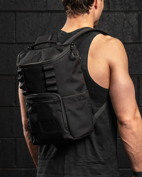 KNKG Mini CORE Backpack in Black being worn by male athlete inside gym