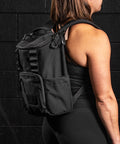 KNKG Mini CORE Backpack in Black being worn by female athlete inside gym