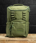 green mini size KNKG CORE Backpack sitting on wooden surface