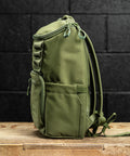 Side profile of green mini size KNKG CORE Backpack 