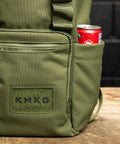 Close up of drink bottle pocket on green mini size KNKG CORE Backpack 