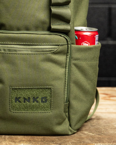Close up of drink bottle pocket on green mini size KNKG CORE Backpack 