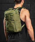 Athlete in gym wearing green mini size KNKG CORE Backpack 