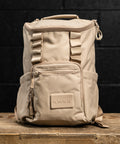 Neutral beige mini size KNKG CORE Backpack on wooden box inside gym