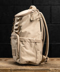 Side profile view of Neutral beige mini size KNKG CORE Backpack 
