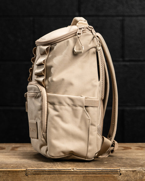 Side profile view of Neutral beige mini size KNKG CORE Backpack 