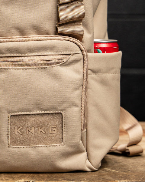 Close up of logo and bottle pocket on Neutral beige mini size KNKG CORE Backpack 