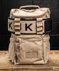 Neutral beige mini size KNKG CORE Backpack on wooden box with lifting belt attached