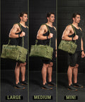 Man holding green bags labeled 'Large', 'Medium', and 'Mini' against a black brick wall.