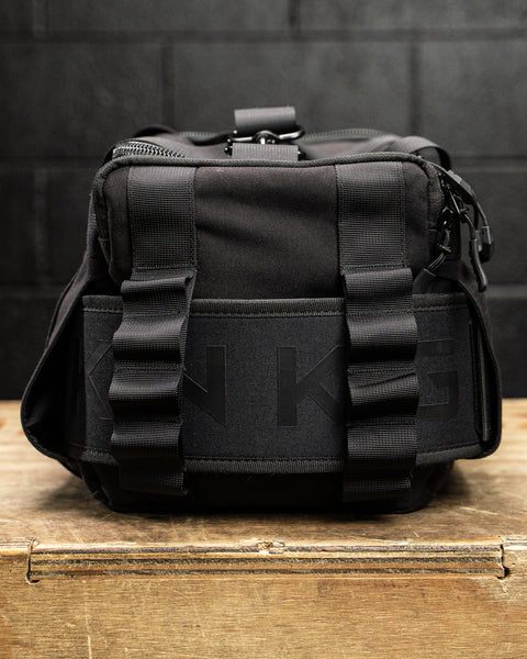 Close up of lifting belt inside sleeves of KNKG mini black CORE Duffel 