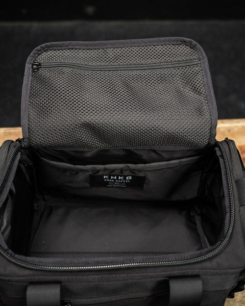 Birds eye view empty internal of KNKG mini black CORE Duffel 