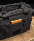 Front pocket on KNKG mini black CORE Duffel packed with brown leather wallet