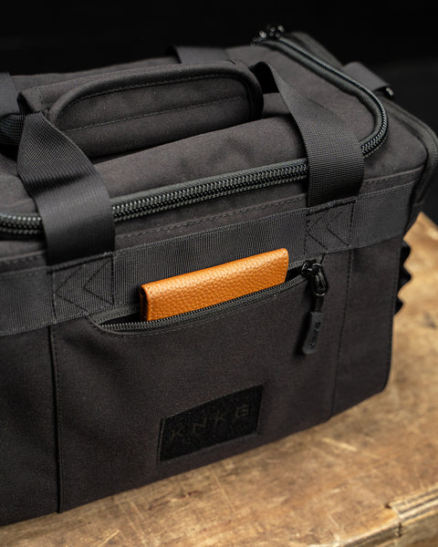 Front pocket on KNKG mini black CORE Duffel packed with brown leather wallet