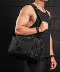 KNKG mini black CORE Duffel being worn over shoulder