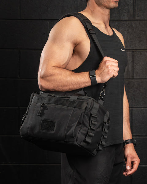 KNKG mini black CORE Duffel being worn over shoulder