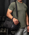 Man wearing KNKG mini black CORE Duffel  over his shoulder