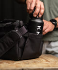 Bottle pocket close up of KNKG mini black CORE Duffel 