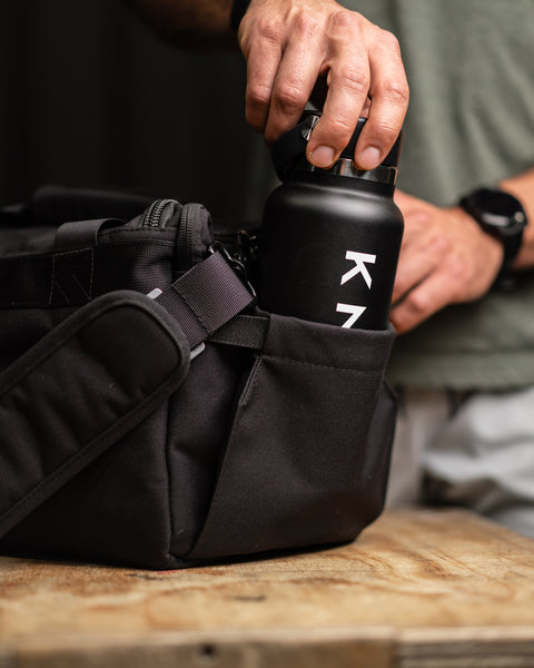 Bottle pocket close up of KNKG mini black CORE Duffel 