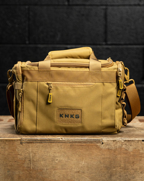 Front view of KNKG desert tan color mini CORE duffel