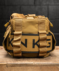 Close up of weightlifting belt packed in sleeve inside KNKG desert tan color mini CORE duffel