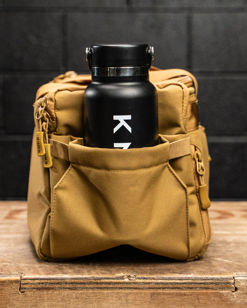 Water bottle inside pocket of KNKG desert tan color mini CORE duffel