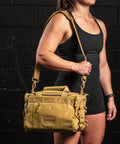 Athlete wearing KNKG desert tan color mini CORE duffel over shoulder