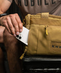 Phone pocket on KNKG desert tan color mini CORE duffel