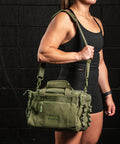 Female athlete wearing green KNKG mini CORE Duffel 