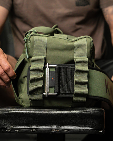 Lifting belt going inside sleeve of side compartment of green KNKG mini duffel