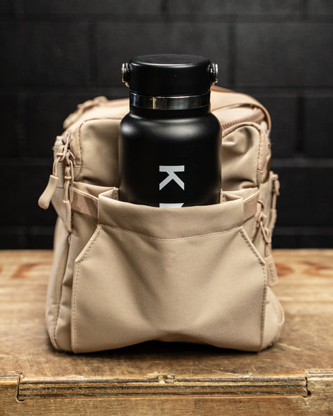 Black water bottle in side pocket of Neutral beige KNKG mini CORE Duffel