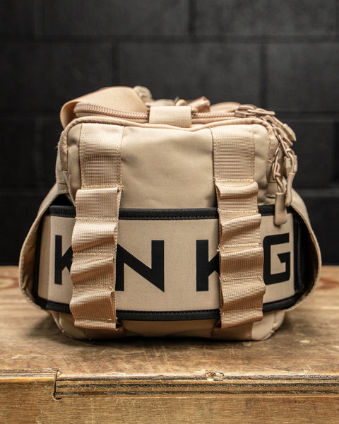 Neutral beige KNKG mini CORE Duffel with matching lifting belt inside side sleeve