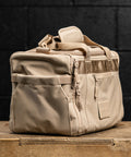 Side pocket view of Neutral beige KNKG mini CORE Duffel