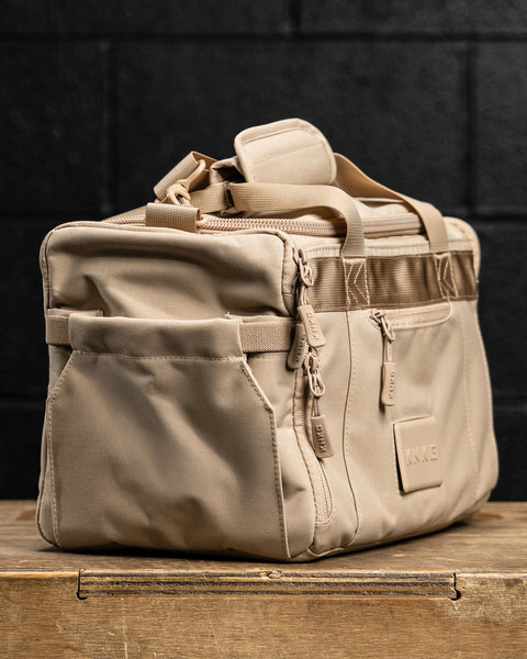 Side pocket view of Neutral beige KNKG mini CORE Duffel