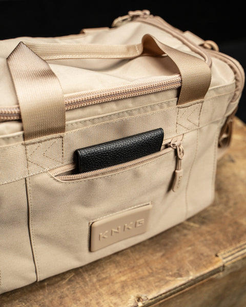 Front pocket of Neutral beige KNKG mini CORE Duffel with wallet inside